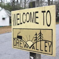 A wooden sign "Welcome to Drew Valley".